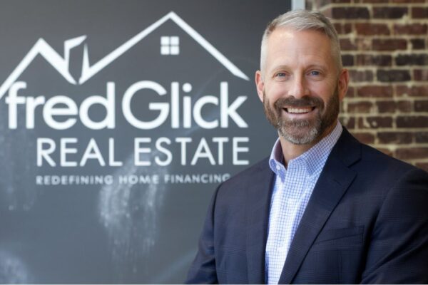 An expert consultation scene showcasing Fred Glick discussing real estate and mortgage solutions with clients in a professional setting.