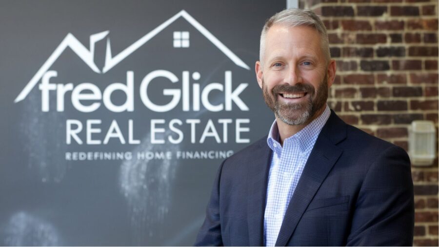 An expert consultation scene showcasing Fred Glick discussing real estate and mortgage solutions with clients in a professional setting.